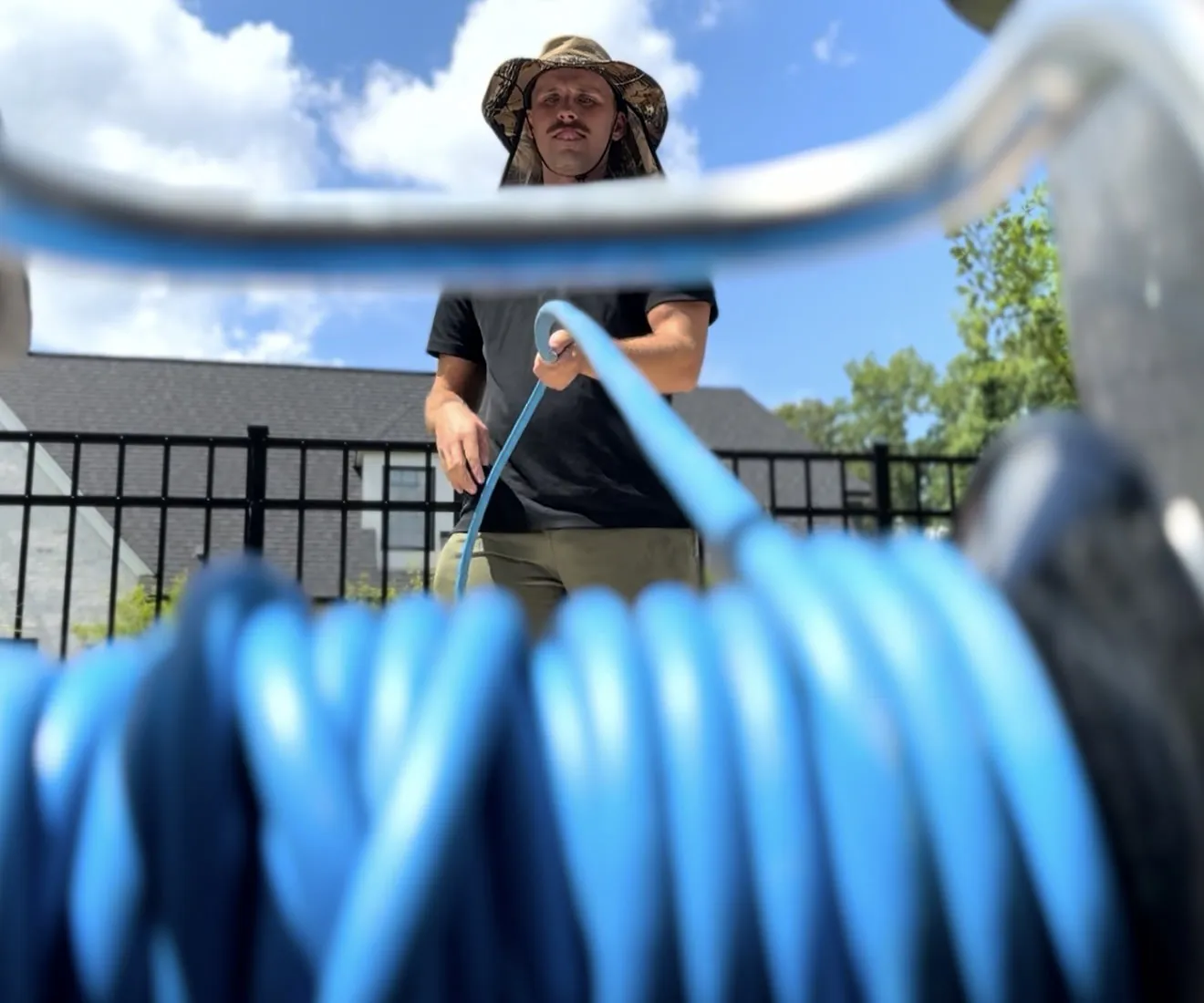 A technician feeding hose onto the reel after finishing a job.